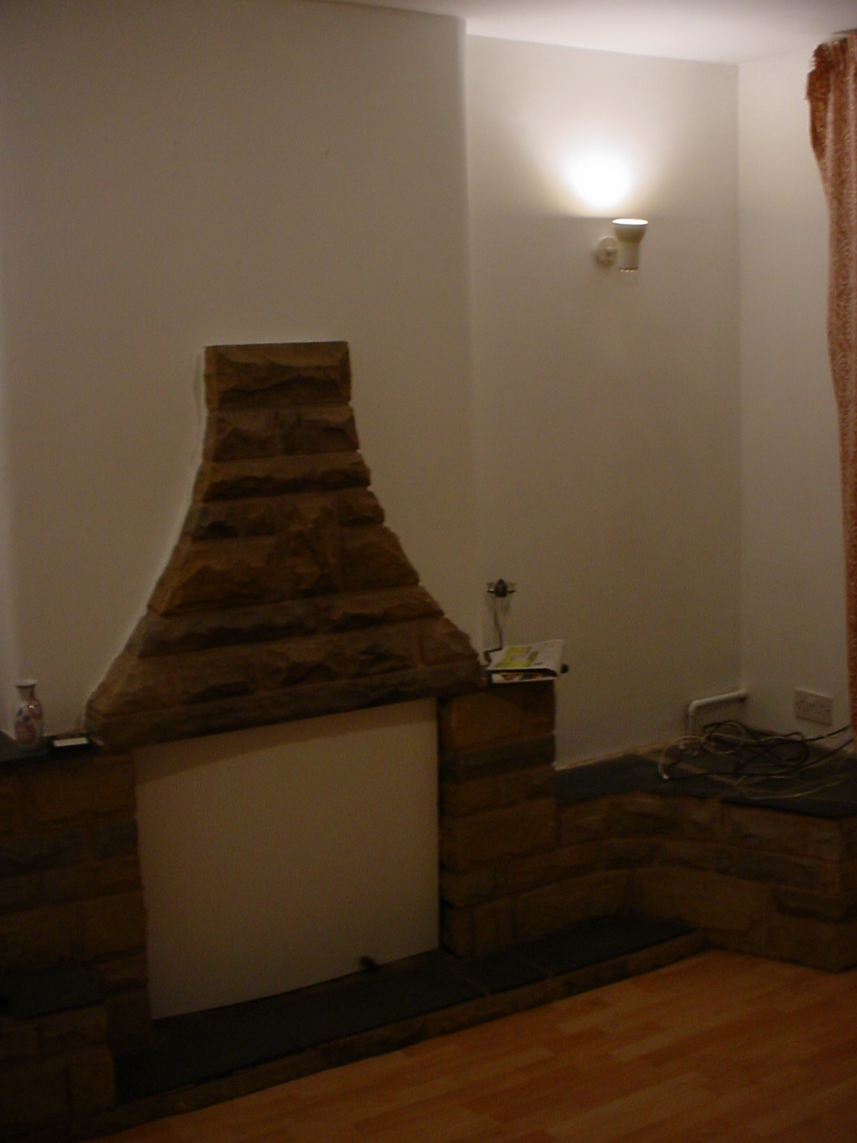 Stone built fireplace in the lounge